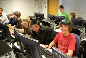 Teens in a computer lab having a good time.